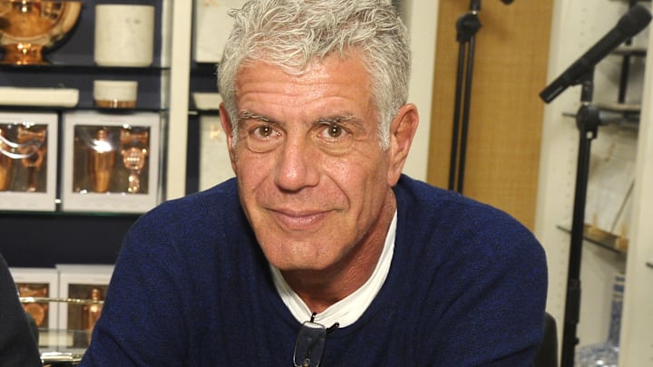 Anthony Bourdain in a blue shirt at a restaurant Anthony Bourdain in a blue shirt at a restaurant