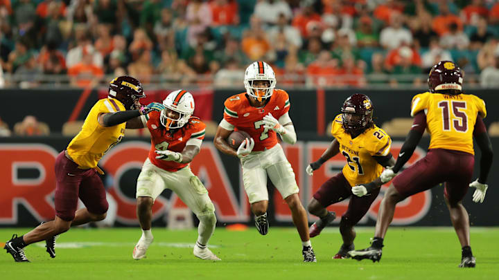Sep 6, 2025; Miami Gardens, Florida, USA; Miami Hurricanes wide receiver CJ Daniels (7) runs with the football against the Bethune-Cookman Wildcats during the second quarter at Hard Rock Stadium. Mandatory Credit: Sam Navarro-Imagn Images