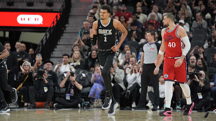 Dec 31, 2024; San Antonio, Texas, USA; San Antonio Spurs center Victor Wembanyama (1) celebrates beside LA Clippers center Ivica Zubac (40) in the first half at Frost Bank Center.