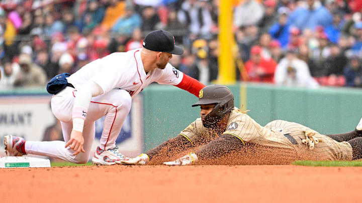 Boston Red Sox shortstop Trevor Story tags San Diego Padres shortstop Xander Bogaerts.