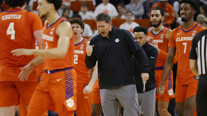 Mar 1, 2025; Charlottesville, Virginia, USA; Clemson Tigers head coach Brad Brownell (center) celebrates with players on the court during the second half against the Virginia Cavaliers at John Paul Jones Arena. Mandatory Credit: Amber Searls-Imagn Images