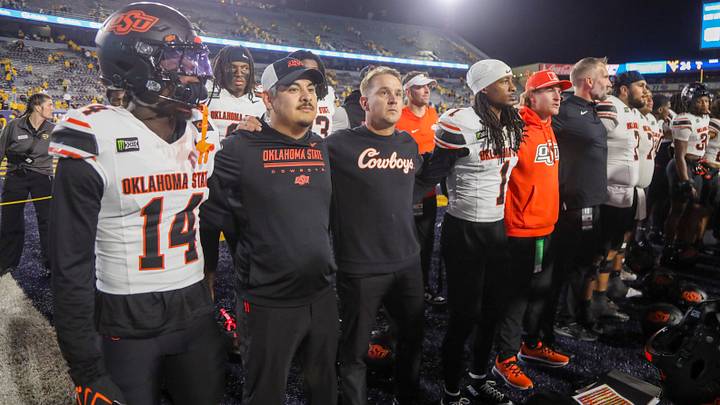 Oklahoma State Cowboys head coach Eric Morris and players.
