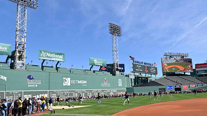 Apr 20, 2025; Boston, Massachusetts, USA; Fans line the field in front of the Green Monster as the Chicago White Sox warm up before a game at Fenway Park. Mandatory Credit: Eric Canha-Imagn Images