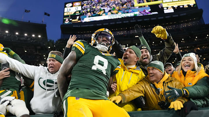 Green Bay Packers running back Josh Jacobs (8) celebrates after scoring a touchdown against the 49ers.