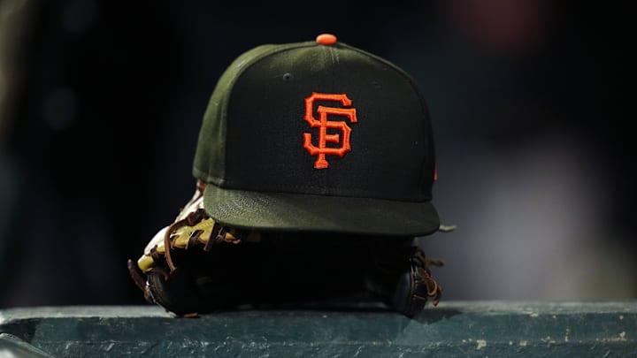 General view of a San Francisco Giants cap and glove during the ninth inning against the Colorado Rockies at Coors Field. General view of a San Francisco Giants cap and glove during the ninth inning against the Colorado Rockies at Coors Field.