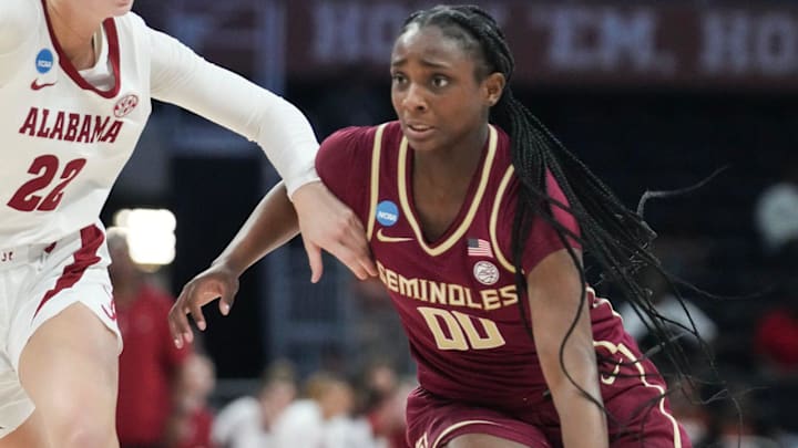 Florida State Seminoles guard Ta'Niya Latson (00) dribbles toward the basket as Alabama Crimson Tide guard Karly Weathers (22) guards her as Alabama takes on Florida State in round one of the NCAA women's basketball tournament at the Moody Center in Austin Friday, March 22, 2024.