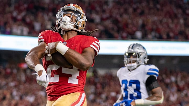 October 8, 2023; Santa Clara, California, USA; San Francisco 49ers running back Jordan Mason (24) scores a touchdown against Dallas Cowboys linebacker Damone Clark (33) during the fourth quarter at Levi's Stadium. Mandatory Credit: Kyle Terada-Imagn Images