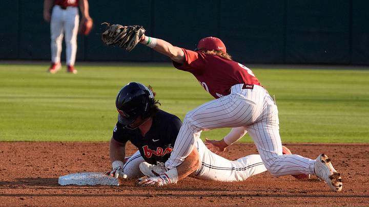 May 15, 2026; Tuscaloosa, AL, USA; Ole Miss base runner Topher Jones is tagged out by Alabama infielder Brennan Holt (4) on a steal attempt in the final week of the regular season at Sewell-Thomas Stadium. May 15, 2026; Tuscaloosa, AL, USA; Ole Miss base runner Topher Jones is tagged out by Alabama infielder Brennan Holt (4) on a steal attempt in the final week of the regular season at Sewell-Thomas Stadium.