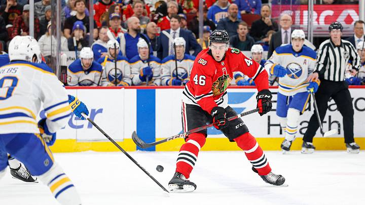 Apr 13, 2026; Chicago, Illinois, USA; Chicago Blackhawks defenseman Louis Crevier (46) shoots the puck against the Buffalo Sabres during the first period at United Center. Mandatory Credit: Kamil Krzaczynski-Imagn Images