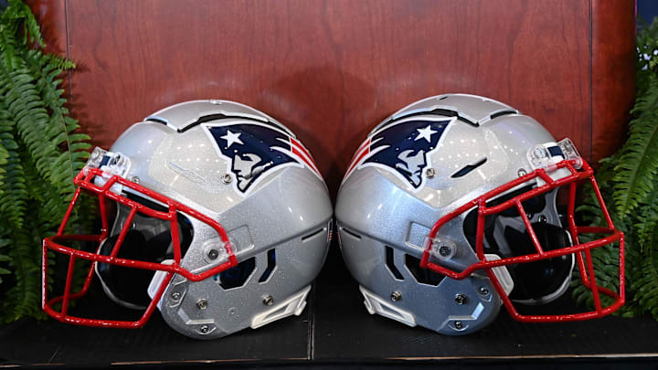 Jan 13, 2025; Foxborough, MA, USA; A pair of New England Patriots helmets sit in front of the podium before a press conference at Gillette Stadium. Mandatory Credit: Eric Canha-Imagn Images