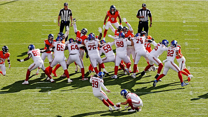 Oct 19, 2025; Denver, Colorado, USA; New York Giants kicker Jude McAtamney (99) kicks a PAT during the second half against the Denver Broncos at Empower Field at Mile High.  