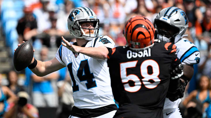 Sep 29, 2024; Charlotte, North Carolina, USA; Carolina Panthers quarterback Andy Dalton (14) looks to pass as Cincinnati Bengals defensive end Joseph Ossai (58) pressures in the first quarter at Bank of America Stadium. Mandatory Credit: Bob Donnan-Imagn Images