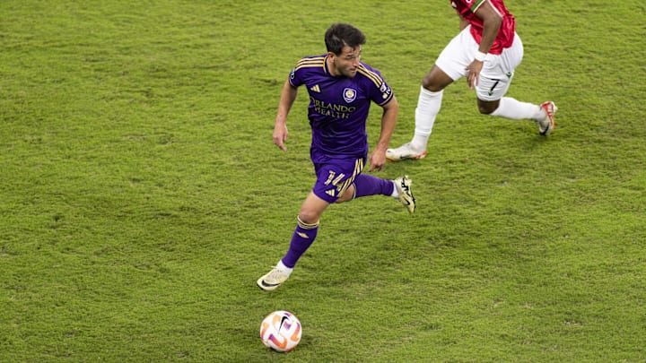 Feb 27, 2024; Orlando, FL, USA; Orlando City midfielder Nico Lodeiro (14) dribbles past Calvary FC