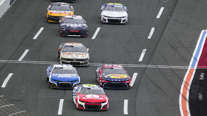 May 25, 2025; Concord, North Carolina, USA; NASCAR Cup Series driver William Byron (24) takes the lead from driver Chase Briscoe (19) and driver Kyle Larson (5) during the Coca Cola 600 at Charlotte Motor Speedway.