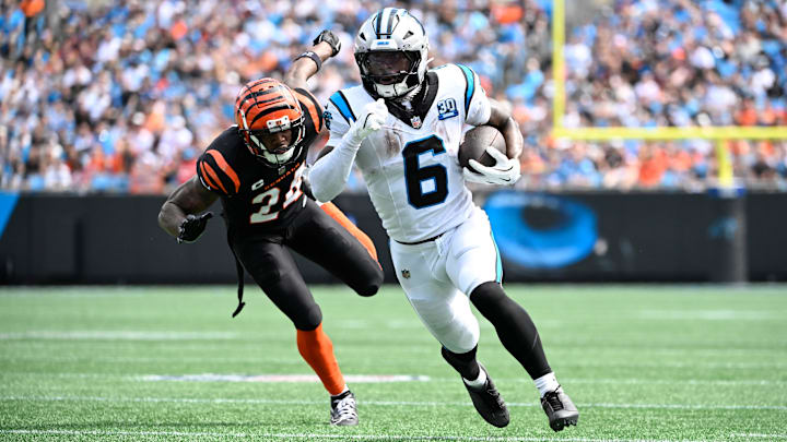 Carolina Panthers running back Miles Sanders withe ball as Cincinnati Bengals safety Vonn Bell defends in the second quarter at Bank of America Stadium.