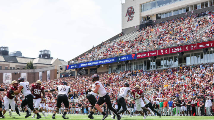 Sep 2, 2023; Chestnut Hill, Massachusetts, USA; Northern Illinois Huskies quarterback Rocky Lombardi (12) runs the ball during the first half against the Northern Illinois Huskies at Alumni Stadium. Mandatory Credit: Paul Rutherford-USA TODAY Sports