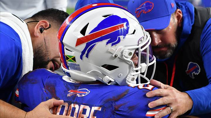 Sep 17, 2026; Orchard Park, New York, USA;  Trainers attend to Buffalo Bills wide receiver DJ Moore (2) after an apparent injury during the first half against the Detroit Lions