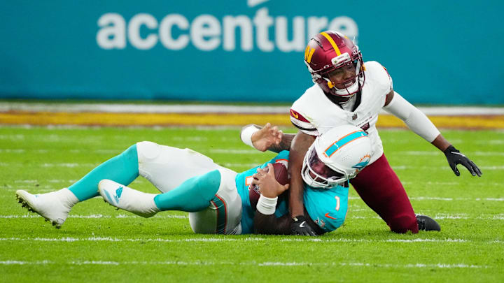 Washington Commanders cornerback Jonathan Jones (31) sacks Miami Dolphins quarterback Tua Tagovailoa (1) in the second quarter during the 2025 NFL Madrid Game at Santiago Bernabeu Stadium. 