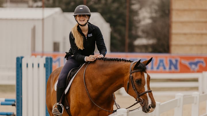 SMU's Hailey Johns has overcome significant health issues during her time with the program. Her work training Oliver has been a big reason she's been able to stay focused. 