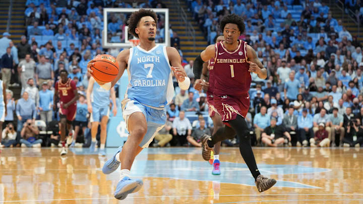 Dec 30, 2025; Chapel Hill, North Carolina, USA; North Carolina Tar Heels guard Seth Trimble (7) on the fast break as Florida State Seminoles guard Martin Somerville (1) defends in the second half at Dean E. Smith Center. Mandatory Credit: Bob Donnan-Imagn Images