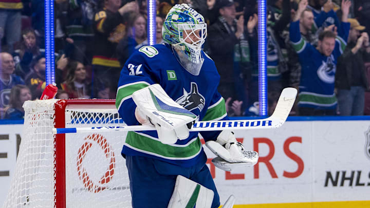 Nov 12, 2024; Vancouver, British Columbia, CAN; Vancouver Canucks goalie Kevin Lankinen (32) celebrates a victory against the Calgary Flames at Rogers Arena. Mandatory Credit: Bob Frid-Imagn Images
