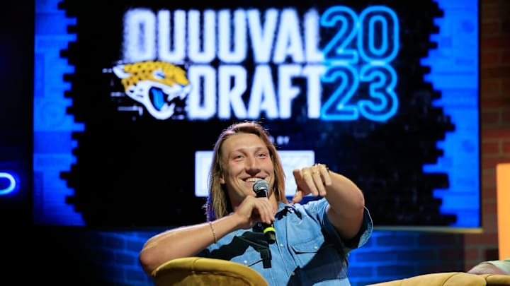 Jacksonville Jaguars quarterback Trevor Lawrence points receiving help finding a fan who asked a