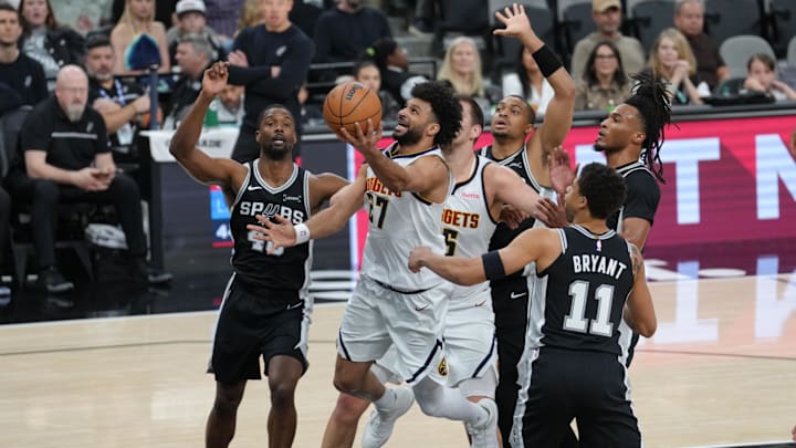 Mar 12, 2026; San Antonio, Texas, USA;  Denver Nuggets guard Jamal Murray (27) shoots in between San Antonio Spurs forwards Harrison Barnes (40) and forward Carter Bryant (11) in the first half at Frost Bank Center. Mandatory Credit: Daniel Dunn-Imagn Images