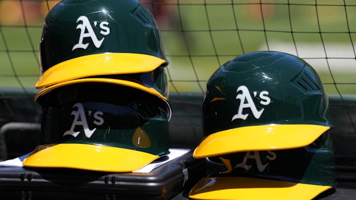 May 29, 2022; Oakland, California, USA; Oakland Athletics helmets are stacked near the field before the game against the Texas Rangers at RingCentral Coliseum. Mandatory Credit: Darren Yamashita-Imagn Images