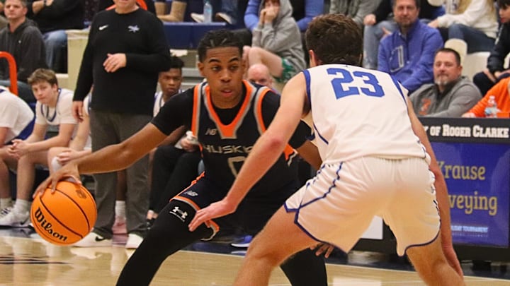 Cameron Woods of Oak Park-River Forest looks to make a move against TJ Gleason of St. Charles North in a consolation bracket game at the 93rd Pontiac Holiday Tournament.