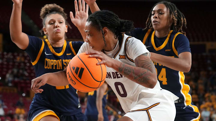 ASU Sun Devils guard Gabby Elliott (0) drives past Coppin State Bald Eagles forward Sydney Burris (21) and guard Khila Morris (24) at Desert Financial Arena on Nov. 3, 2025.