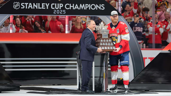 Gary Bettman, NHL Commissioner, presents Florida Panthers center Sam Bennett the Conn Smythe Trophy.