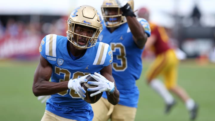 Nov 18, 2023; Los Angeles, California, USA; UCLA Bruins defensive back Alex Johnson (36) returns a fumble for a touchdown during the third quarter against the USC Trojans at United Airlines Field at Los Angeles Memorial Coliseum. 