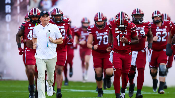 Nov 22, 2025; Columbia, South Carolina, USA; South Carolina Gamecocks head coach Shane Beamer leads his team onto the field before their game against the Coastal Carolina Chanticleers at Williams-Brice Stadium. Mandatory Credit: Jeff Blake-Imagn Images