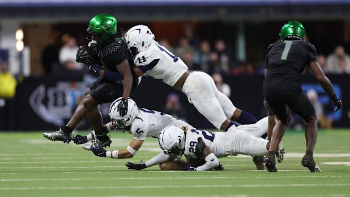 Dec 7, 2024; Indianapolis, IN, USA; Oregon Ducks running back Noah Whittington (6) is tackled by Penn State Nittany Lions defensive end Abdul Carter (11) during the fourth quarter in the 2024 Big Ten Championship game at Lucas Oil Stadium. Dec 7, 2024; Indianapolis, IN, USA; Oregon Ducks running back Noah Whittington (6) is tackled by Penn State Nittany Lions defensive end Abdul Carter (11) during the fourth quarter in the 2024 Big Ten Championship game at Lucas Oil Stadium.
