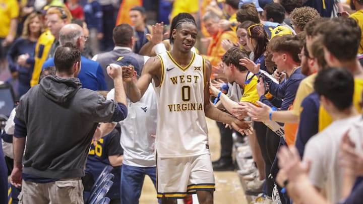 Mar 6, 2026; Morgantown, West Virginia, USA; West Virginia Mountaineers forward Brenen Lorient (0) celebrates with fans after defeating the UCF Knights at Hope Coliseum. Mandatory Credit: Ben Queen-Imagn Images