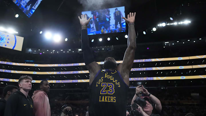 Nov 18, 2025; Los Angeles, California, USA; Los Angeles Lakers forward LeBron James (23) throws powdered chalk into the air during the game against the Utah Jazz at Crypto.com Arena. Mandatory Credit: Kirby Lee-Imagn Images