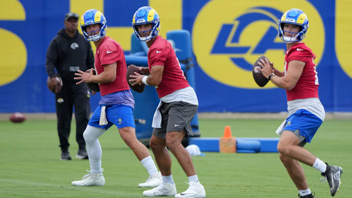 Jun 3, 2025; Woodland Hills, CA, USA; Los Angeles Rams quarterbacks Matthew Stafford (left), Jimmy Garoppolo (center) and Stetson Bennett throw the ball during organized team activities at Rams Practice Facility. Mandatory Credit: Kirby Lee-Imagn Images