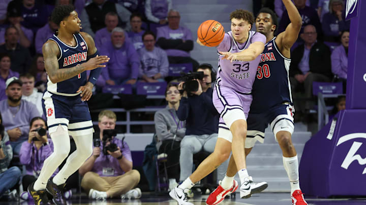 Feb 11, 2025; Manhattan, Kansas, USA; Kansas State Wildcats forward Coleman Hawkins (33) passes the ball away from Arizona Wildcats forward Tobe Awaka (30) during the second half at Bramlage Coliseum. Mandatory Credit: Scott Sewell-Imagn Images Feb 11, 2025; Manhattan, Kansas, USA; Kansas State Wildcats forward Coleman Hawkins (33) passes the ball away from Arizona Wildcats forward Tobe Awaka (30) during the second half at Bramlage Coliseum. Mandatory Credit: Scott Sewell-Imagn Images