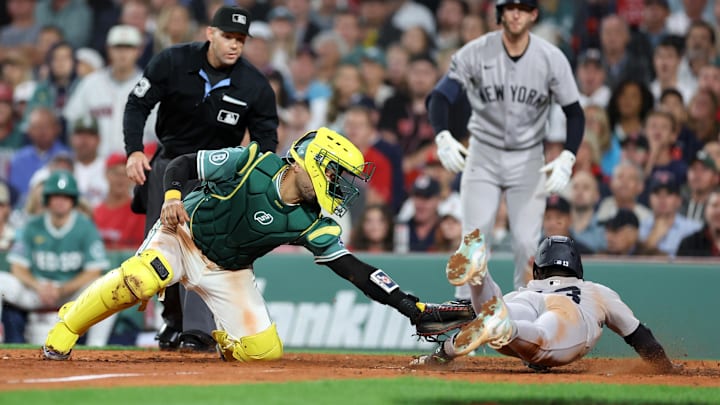 Sep 12, 2025; Boston, Massachusetts, USA; Boston Red Sox catcher Carlos Narvaez (75) tags out New York Yankees second baseman Jazz Chisholm Jr (13) during the eighth inning at Fenway Park. Mandatory Credit: Paul Rutherford-Imagn Images