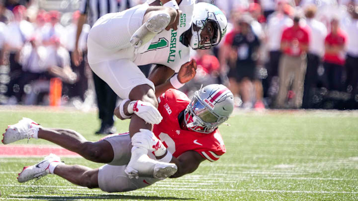Sep 21, 2024; Columbus, Ohio, USA; Ohio State Buckeyes safety Caleb Downs (2) tackles Marshall Thundering Herd quarterback Braylon Braxton (1) in the second half at Ohio Stadium on Saturday.