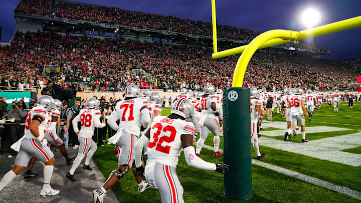 Sep 28, 2024; East Lansing, Michigan, USA; Ohio State Buckeyes take the field before the game against the Michigan State Spartans at Spartan Stadium on Saturday.