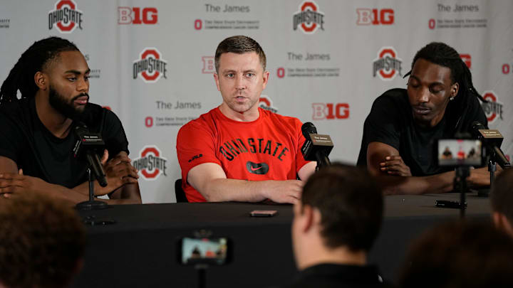 Jul 9, 2024; Columbus, OH, USA; From left, Ohio State Buckeyes guard Evan Mahaffey, head coach Jake Diebler and forward Aaron Bradshaw talk to reporters prior to a summer workout in the practice gym at the Schottenstein Center.