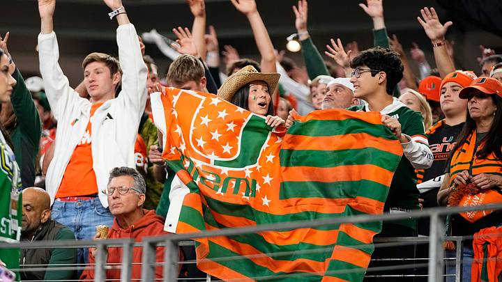 Miami Hurricanes fans cheer during the Cotton Bowl at AT&T Stadium in Arlington, Texas for the College Football Playoff quarterfinal game against the Ohio State Buckeyes on Dec. 31, 2025. Ohio State lost 24-14.