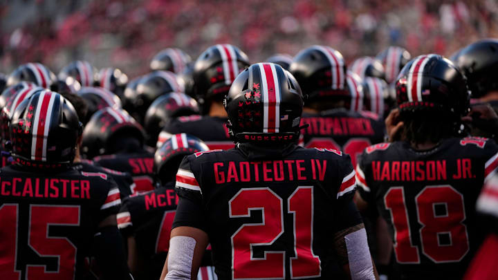 Wearing black uniforms, the Ohio State Buckeyes prepare to take the field. Wearing black uniforms, the Ohio State Buckeyes prepare to take the field.