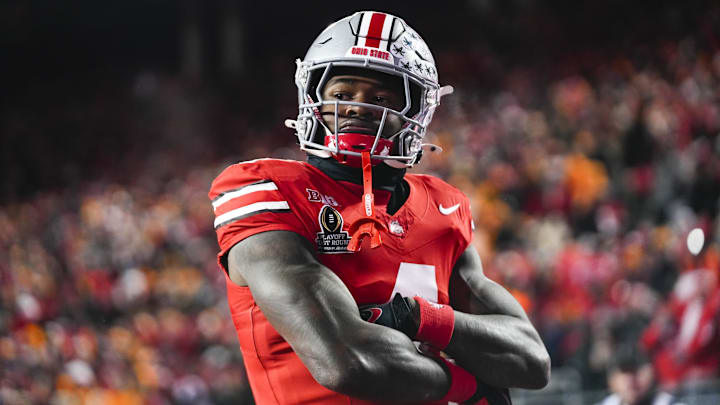 Dec 21, 2024; Columbus, Ohio, USA; Ohio State Buckeyes wide receiver Jeremiah Smith (4) celebrates after scoring a touchdown against Tennessee Volunteers defensive back Rickey Gibson III (1) in the first half at Ohio Stadium. Dec 21, 2024; Columbus, Ohio, USA; Ohio State Buckeyes wide receiver Jeremiah Smith (4) celebrates after scoring a touchdown against Tennessee Volunteers defensive back Rickey Gibson III (1) in the first half at Ohio Stadium.
