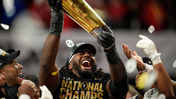 Ohio State Buckeyes wide receiver Jeremiah Smith (4) holds the trophy following the 34-23 win over the Notre Dame Fighting Irish to win the College Football Playoff National Championship at Mercedes-Benz Stadium in Atlanta on Jan. 21, 2025.