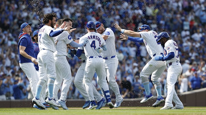 Jun 15, 2025; Chicago, Illinois, USA; Chicago Cubs left fielder Ian Happ (8) celebrates with teammates after hitting a walk-off single against the Pittsburgh Pirates during the tenth inning at Wrigley Field.