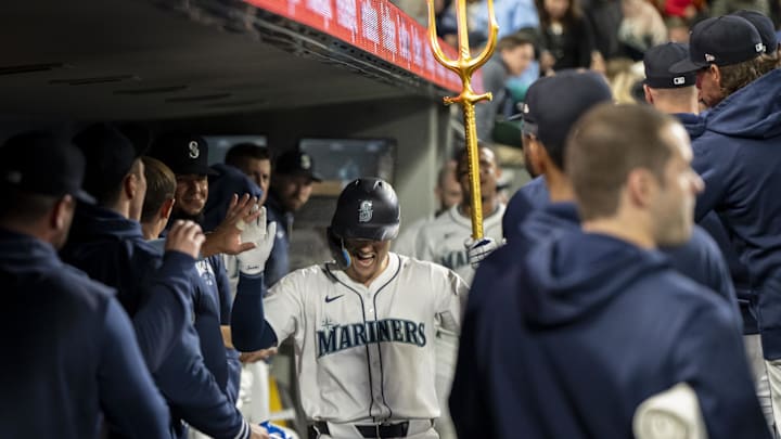 May 29, 2024; Seattle, Washington, USA; Seattle Mariners right fielder Dominic Canzone (8) celebraters in the dugout after hitting a solo home run during the fifth inning against the Houston Astros at T-Mobile Park. Mandatory Credit: Stephen Brashear-USA TODAY Sports
