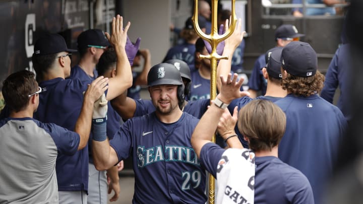 Seattle Mariners catcher Cal Raleigh celebrates with teammates in the dugout after hitting a two-run home run against the Chicago White Sox at Guaranteed Rate Field. Seattle Mariners catcher Cal Raleigh celebrates with teammates in the dugout after hitting a two-run home run against the Chicago White Sox at Guaranteed Rate Field.