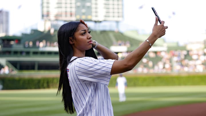 Chicago Sky forward Angel Reese prepares to throw out a ceremonial first pitch before a baseball game between the Chicago Cubs and Atlanta Braves at Wrigley Field.